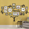Wall decor with family photo frames and 'Family' text on a yellow wall.